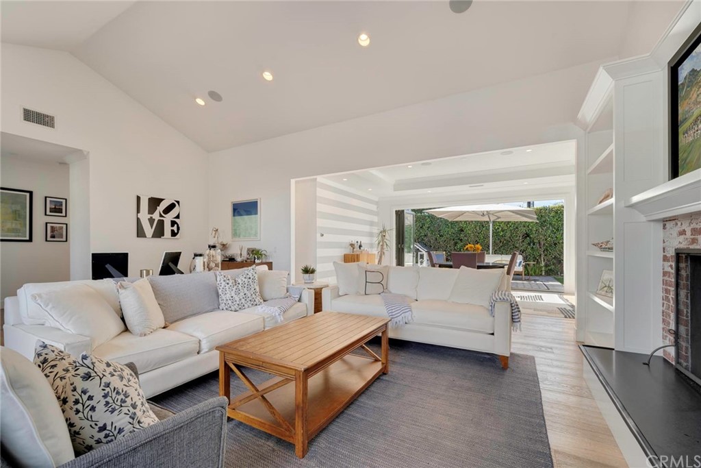 277 Knox Place Costa Mesa, CA 92627 - Photo 3 of 21 a living room with furniture fireplace and a large window