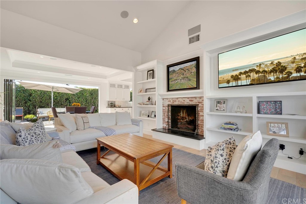 277 Knox Place Costa Mesa, CA 92627 - Photo 4 of 21 a living room with furniture large window and a fireplace