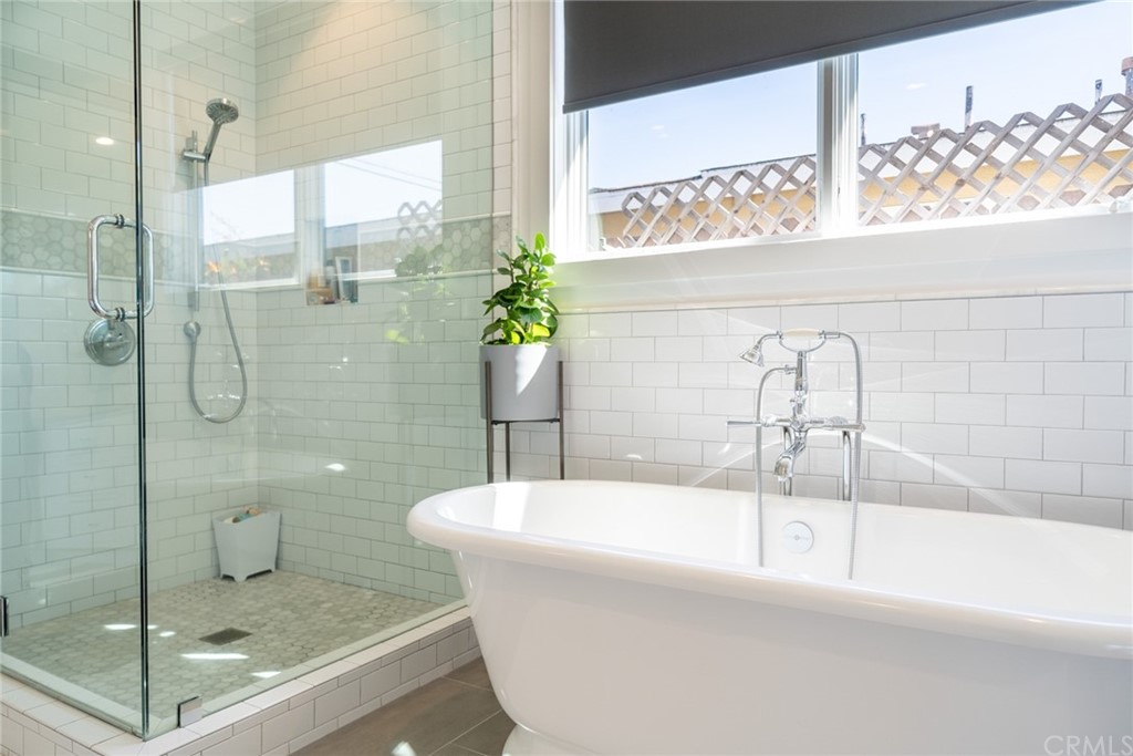 277 Knox Place Costa Mesa, CA 92627 - Photo 9 of 21 a bathroom with a bathtub and a shower