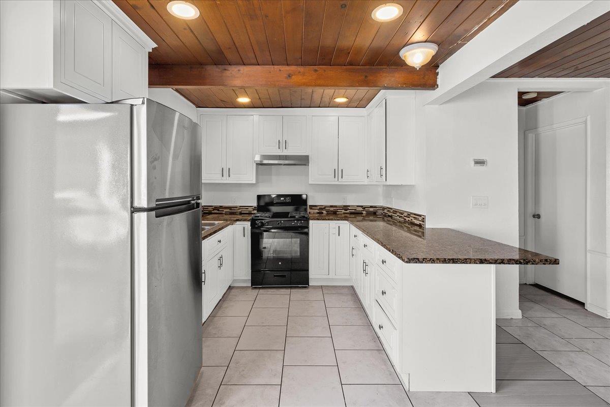 1238 Granada Avenue Salinas, CA 93906 - Photo 13 of 36 a kitchen with stainless steel appliances granite countertop a refrigerator and a stove