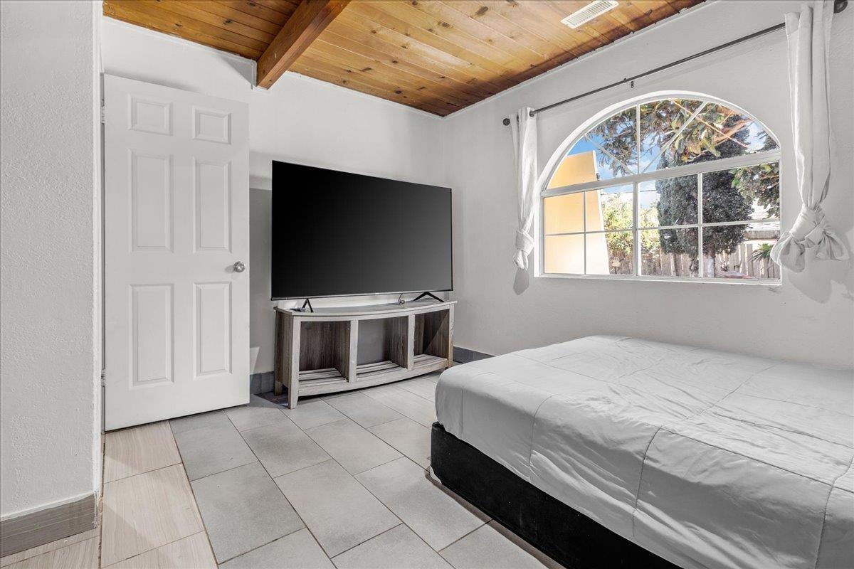 1238 Granada Avenue Salinas, CA 93906 - Photo 19 of 36 a spacious bedroom with a bed and a flat screen tv