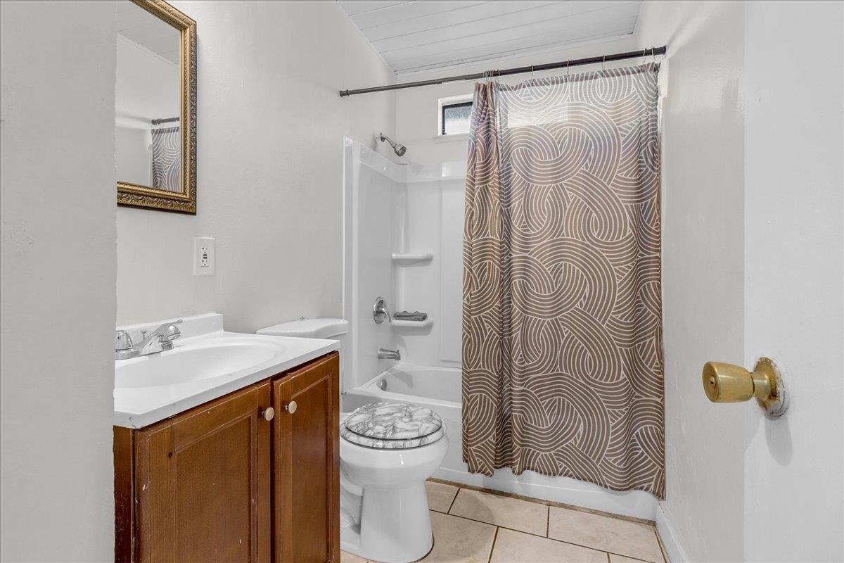 1238 Granada Avenue Salinas, CA 93906 - Photo 20 of 36 a bathroom with a granite countertop sink a toilet and shower