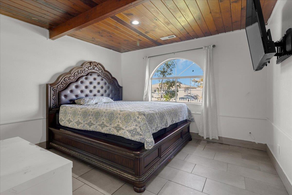 1238 Granada Avenue Salinas, CA 93906 - Photo 22 of 36 a bedroom with a bed and a painting on the wall