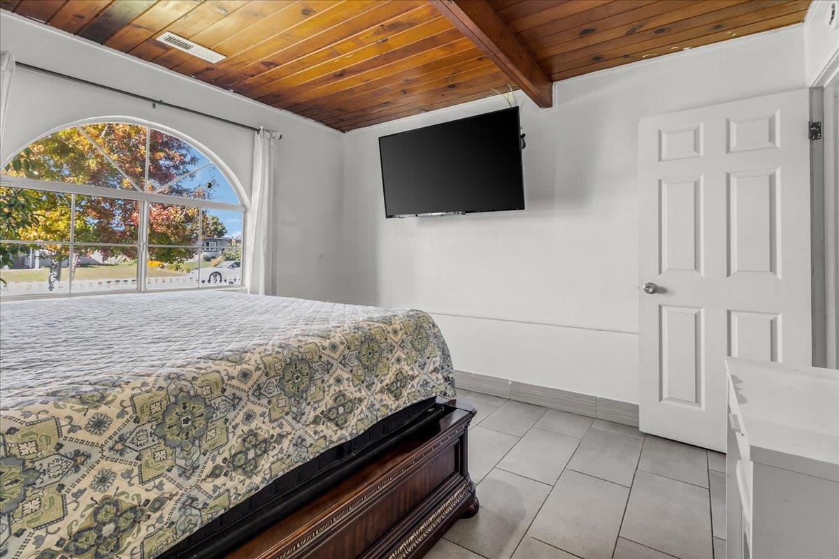 1238 Granada Avenue Salinas, CA 93906 - Photo 23 of 36 a bedroom with a bed and a flat screen tv