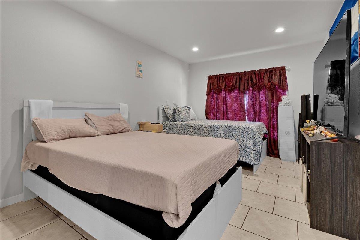 1238 Granada Avenue Salinas, CA 93906 - Photo 30 of 36 a bedroom with a bed and a flat screen television