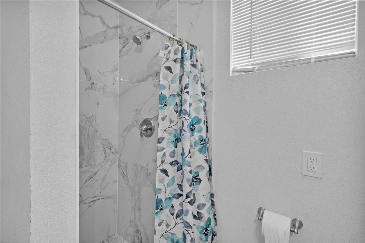1238 Granada Avenue Salinas, CA 93906 - Photo 34 of 36 a bathroom with a shower curtain