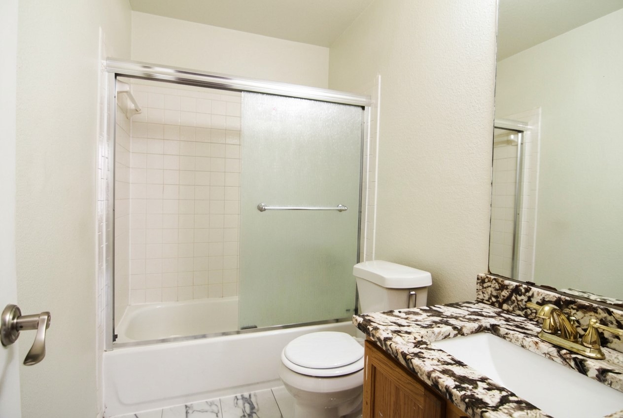 1431 Roxanne's Run Pflugerville, TX 78660 - Photo 15 of 29 Bathroom with vanity and combined bath / shower with glass door