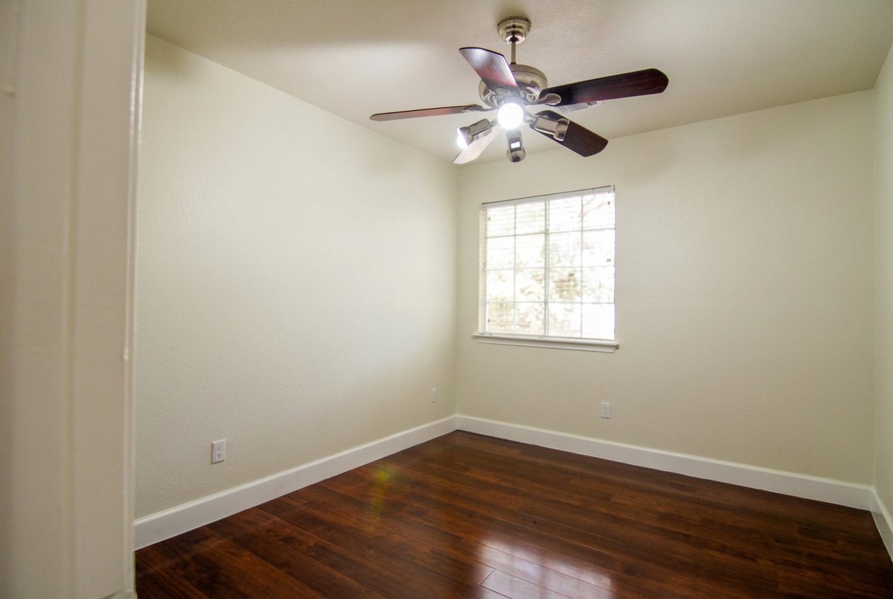1431 Roxanne's Run Pflugerville, TX 78660 - Photo 18 of 29 Unfurnished room featuring dark wood-style floors and ceiling fan