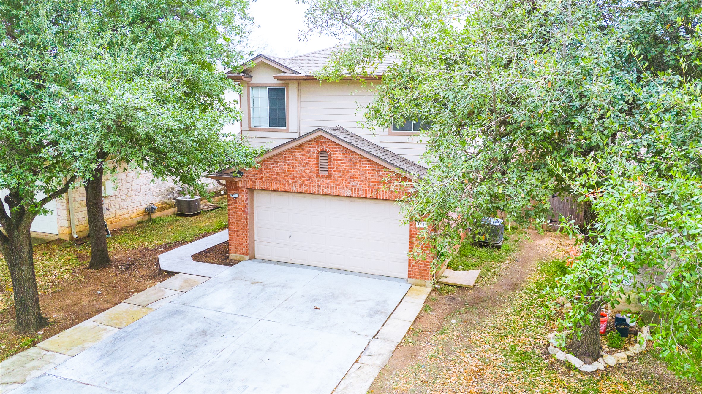 1431 Roxanne's Run Pflugerville, TX 78660 - Photo 2 of 29 Traditional-style house with concrete driveway and brick siding