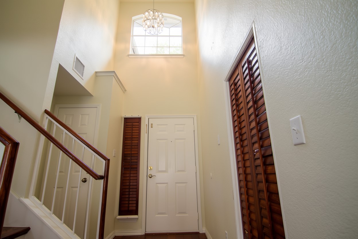 1431 Roxanne's Run Pflugerville, TX 78660 - Photo 7 of 29 Entryway with hanging lights and wood finished floors