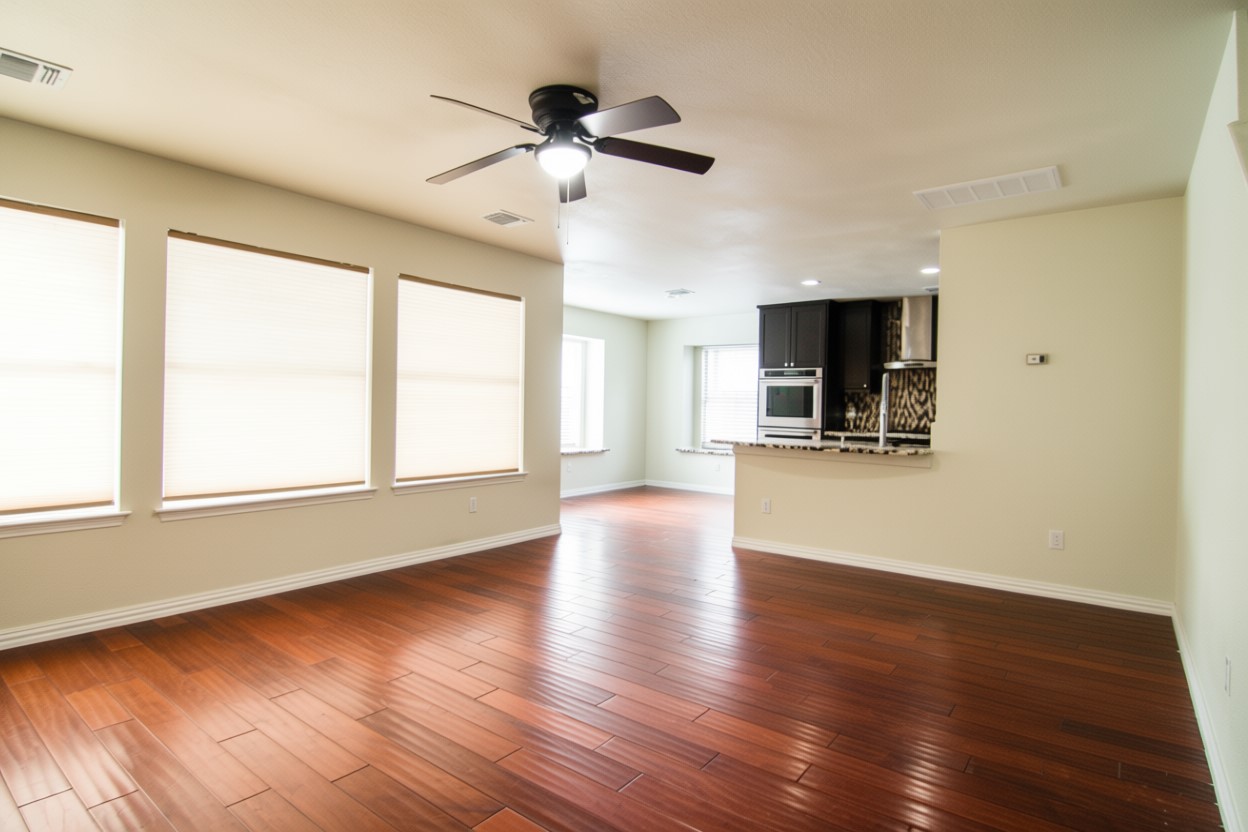 1431 Roxanne's Run Pflugerville, TX 78660 - Photo 8 of 29 Unfurnished living room featuring a ceiling fan, dark wood finished floors, and recessed lighting