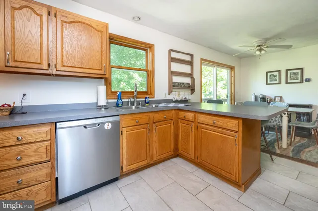 a kitchen with stainless steel appliances granite countertop a sink and cabinets