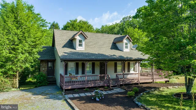 a front view of a house with a garden and plants