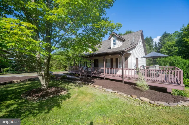 a view of a house with backyard and sitting area