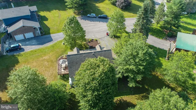 an aerial view of a house with a yard and lake view