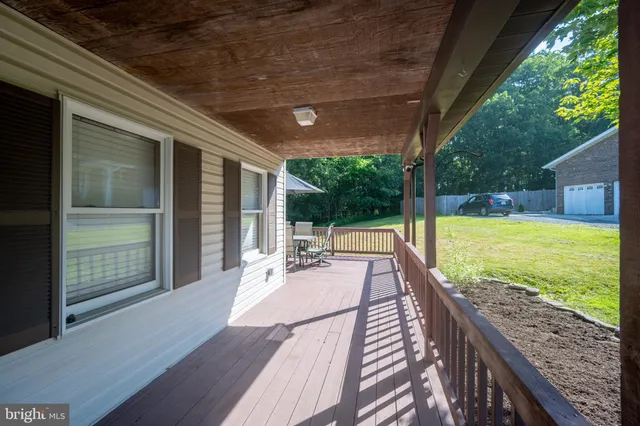 a view of balcony with wooden floor and outdoor seating
