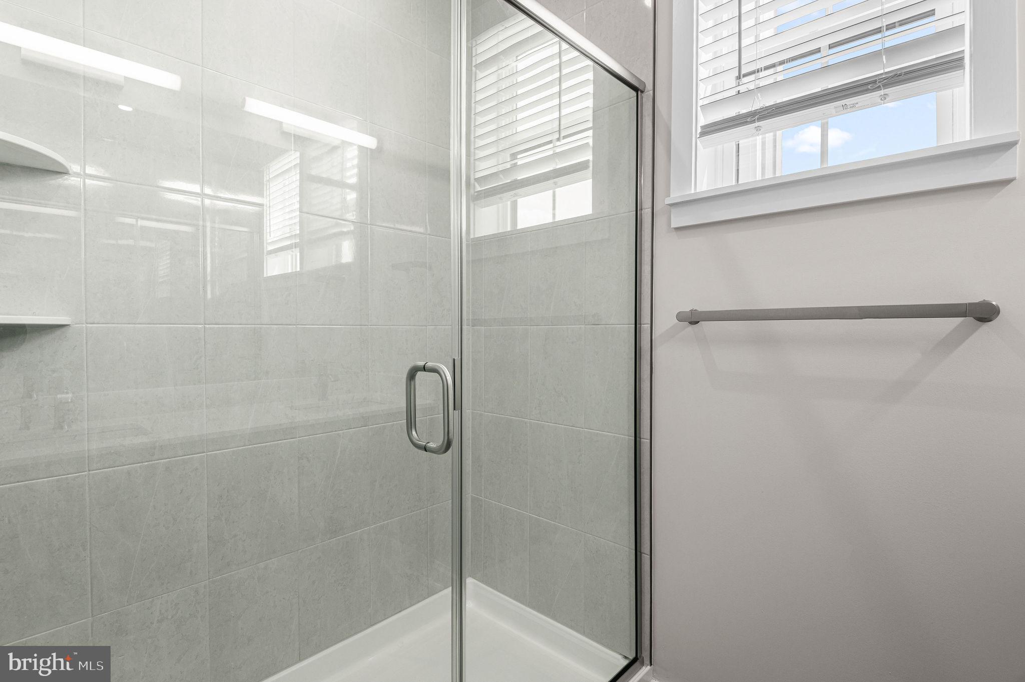 26 South York Road, Unit 409 Hatboro, PA 19040 - Photo 11 of 16 Modern glass shower with natural light.