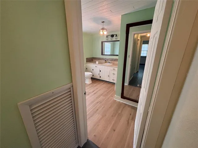 a view of hallway with wooden floor