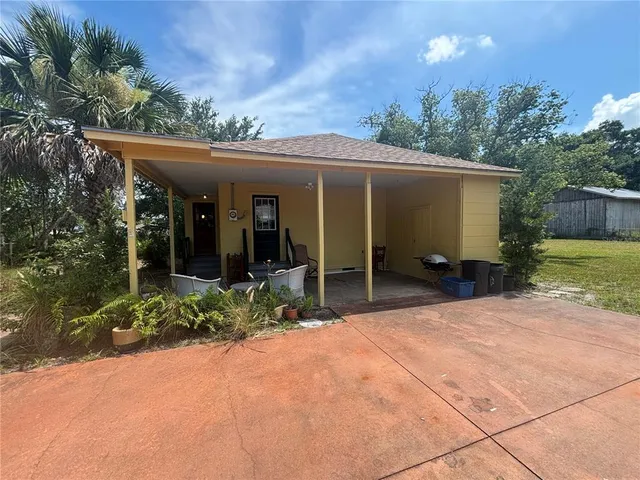 a view of a house with backyard porch and sitting area