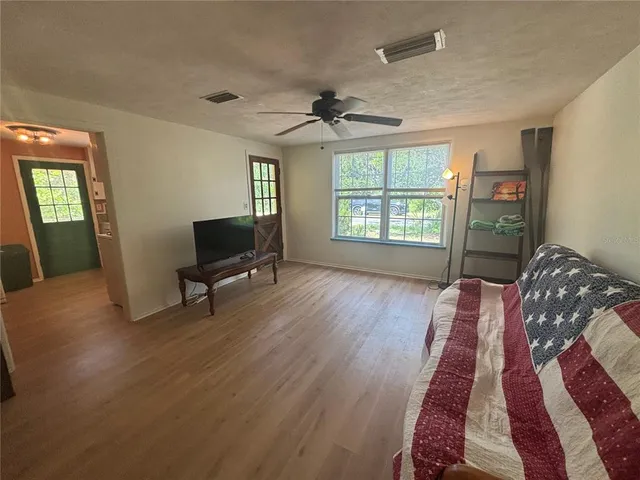 a living room with furniture and a wooden floor