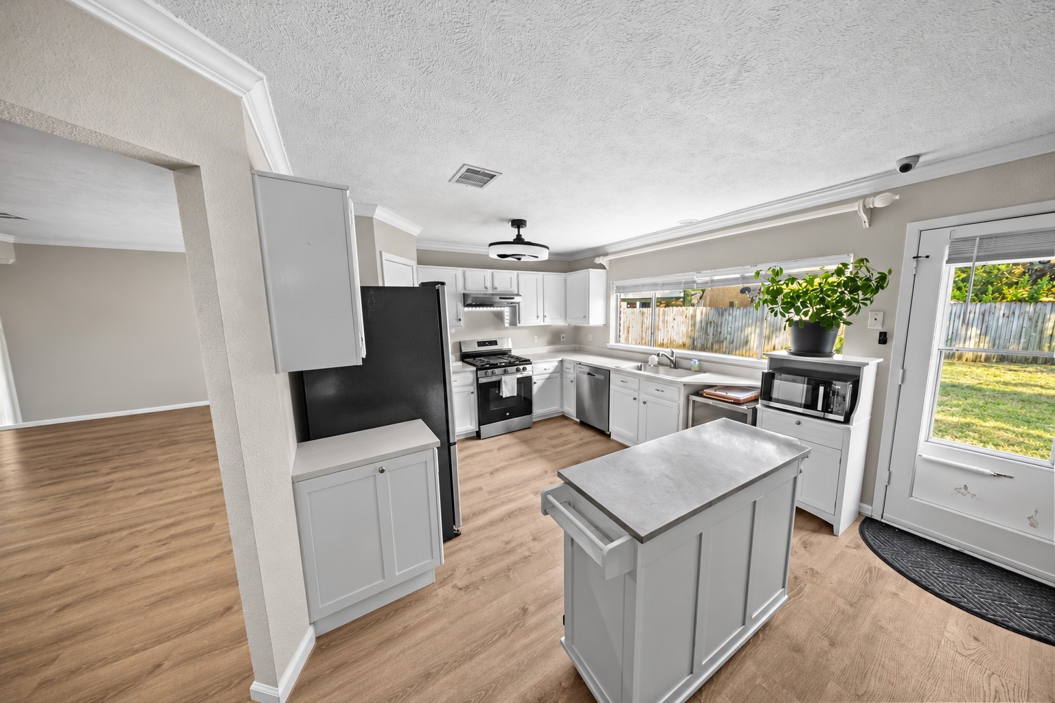 9107 Towerstone Court Spring, TX 77379 - Photo 13 of 42 Modern stainless steel gas stove with multiple burners, set against a neutral countertop and white cabinetry, perfect for culinary enthusiasts.