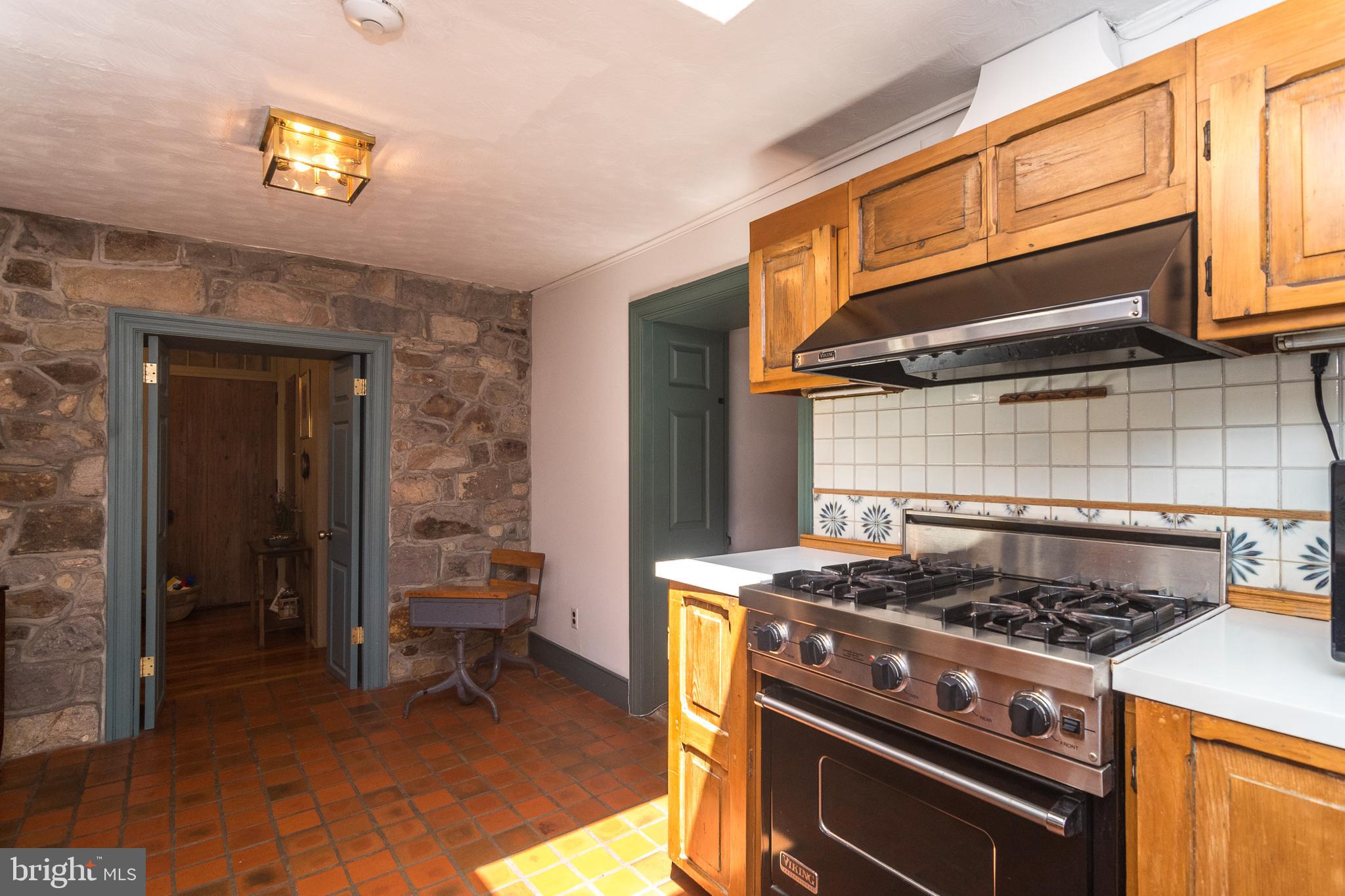1960 South Easton Road Doylestown, PA 18901 - Photo 32 of 57 Exposed stone wall, terra cotta floors.