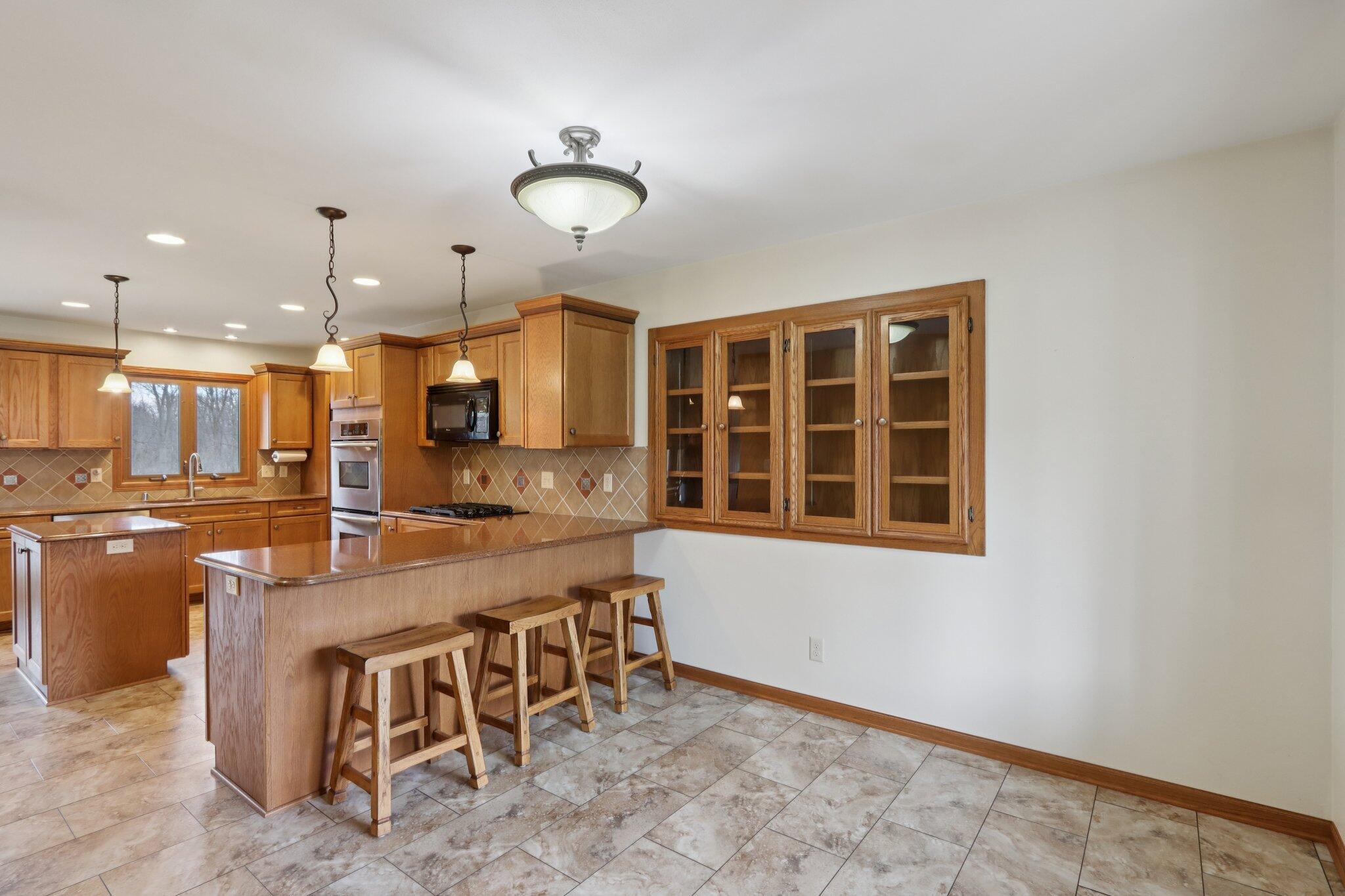 N61W29595 South Woodfield Road Merton, WI 53029 - Photo 10 of 44 Counter seating as well as area for dinette table