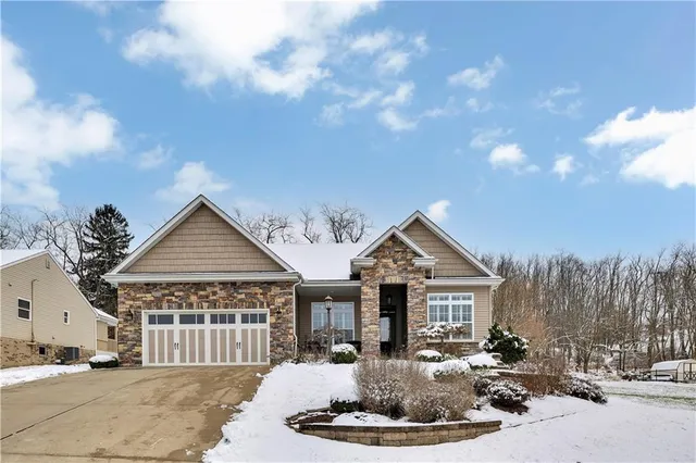 a front view of a house with a yard outdoor seating and garage