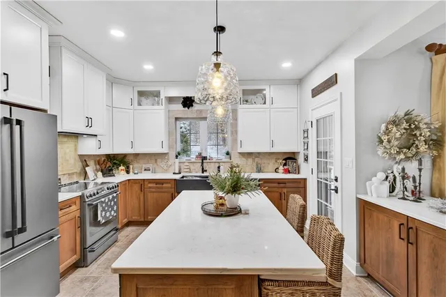 a kitchen with sink a refrigerator and cabinets