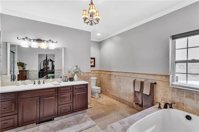 a bathroom with a tub sink and mirror