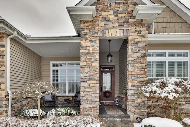 a front view of a house with outdoor seating