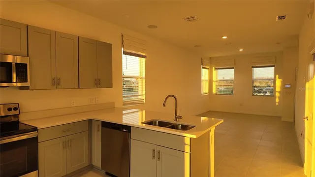 a kitchen with a sink cabinets and appliances