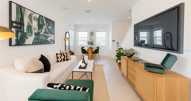 a living room with furniture and wooden floor