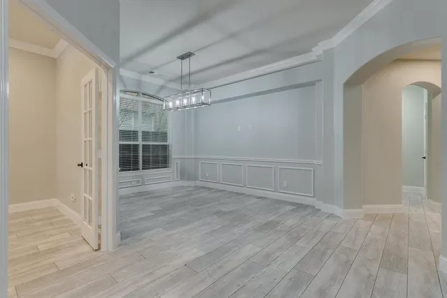 a view of a room with wooden floor and white walls