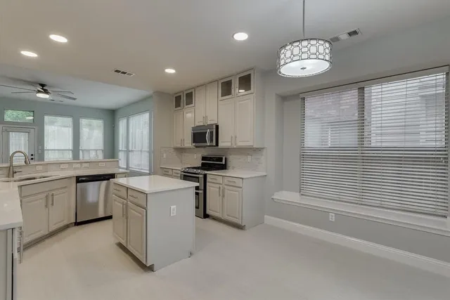 a kitchen with counter top space cabinets and stainless steel appliances
