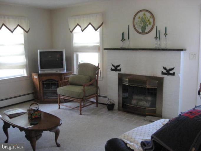 2805 Harford Road Fallston, MD 21047 - Photo 7 of 9 a living room with furniture a flat screen tv and a fireplace
