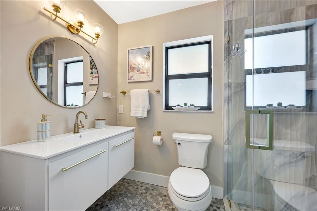 761 99th Avenue North Naples, FL 34108 - Photo 11 of 31 Full bathroom featuring vanity and a marble finish shower