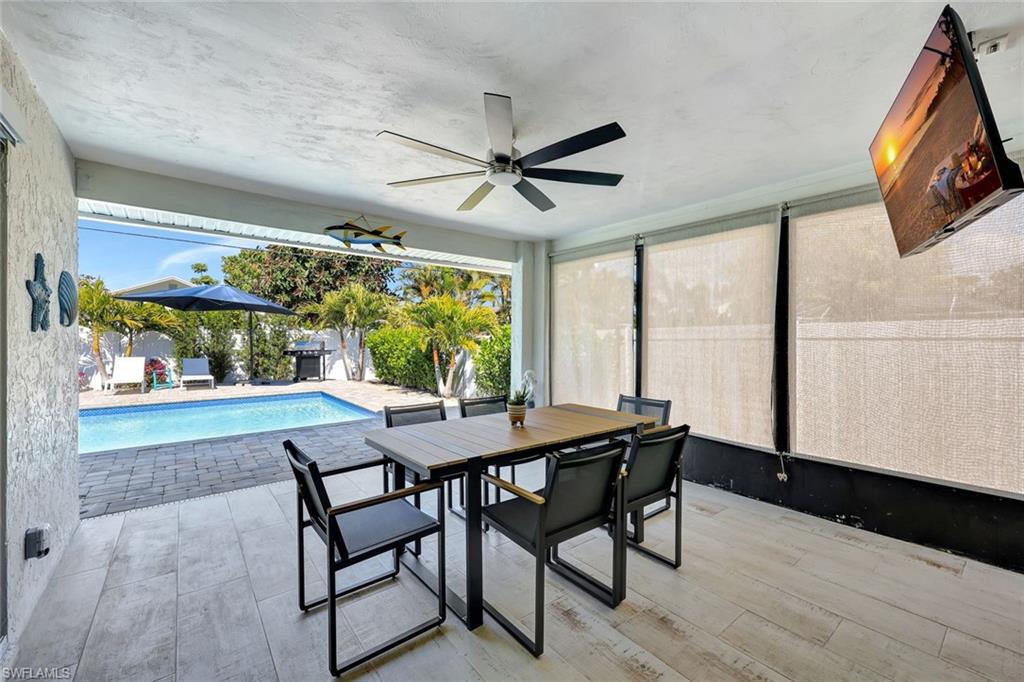 761 99th Avenue North Naples, FL 34108 - Photo 16 of 31 Outdoor pool with outdoor dining space, a grill, a patio area, and a sunroom