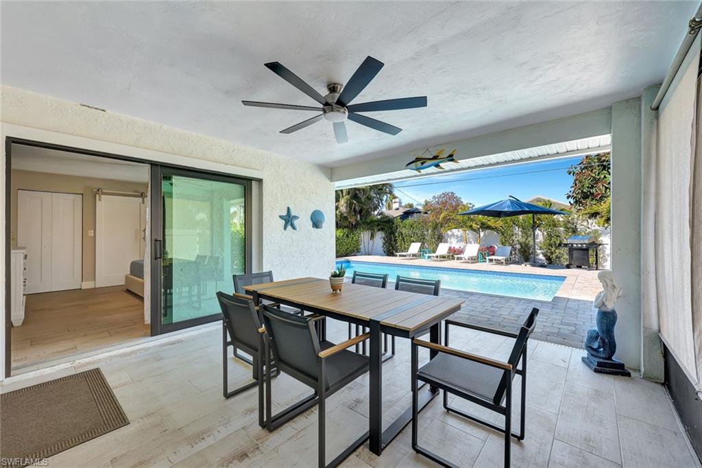 761 99th Avenue North Naples, FL 34108 - Photo 17 of 31 View of patio featuring an outdoor pool, outdoor dining space, a ceiling fan, and grilling area