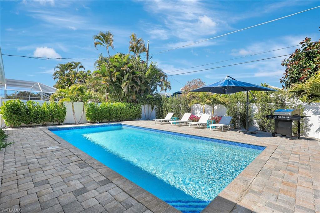 761 99th Avenue North Naples, FL 34108 - Photo 18 of 31 View of pool featuring patio surround, a fenced backyard, and area for grilling