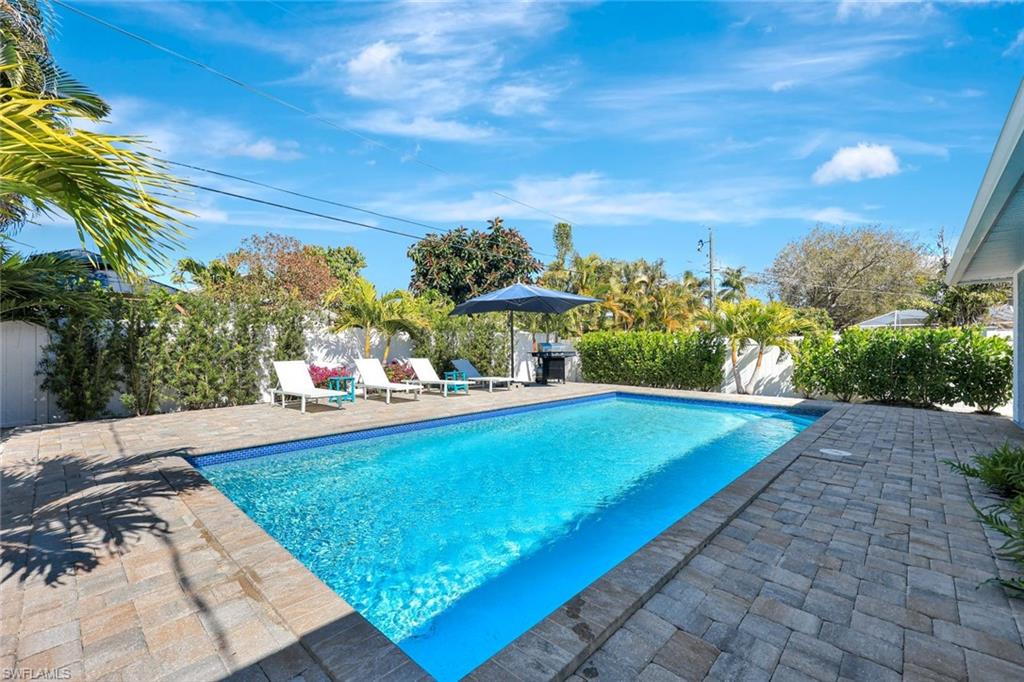 761 99th Avenue North Naples, FL 34108 - Photo 19 of 31 View of pool featuring patio surround, a fenced backyard, and area for grilling