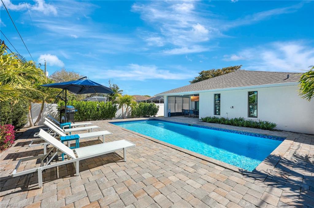 761 99th Avenue North Naples, FL 34108 - Photo 20 of 31 View of pool featuring patio surround and a sunroom