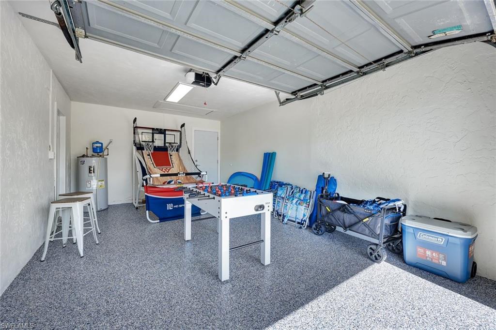 761 99th Avenue North Naples, FL 34108 - Photo 28 of 31 Garage with a textured wall and water heater