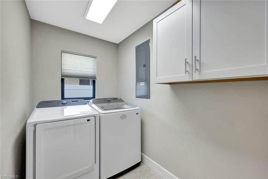 761 99th Avenue North Naples, FL 34108 - Photo 30 of 31 Laundry area with cabinet space, electric panel, and washer and clothes dryer