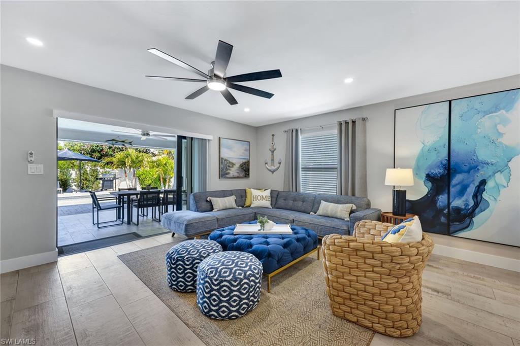 761 99th Avenue North Naples, FL 34108 - Photo 8 of 31 Living room featuring light wood finished floors, healthy amount of natural light, ceiling fan, and recessed lighting
