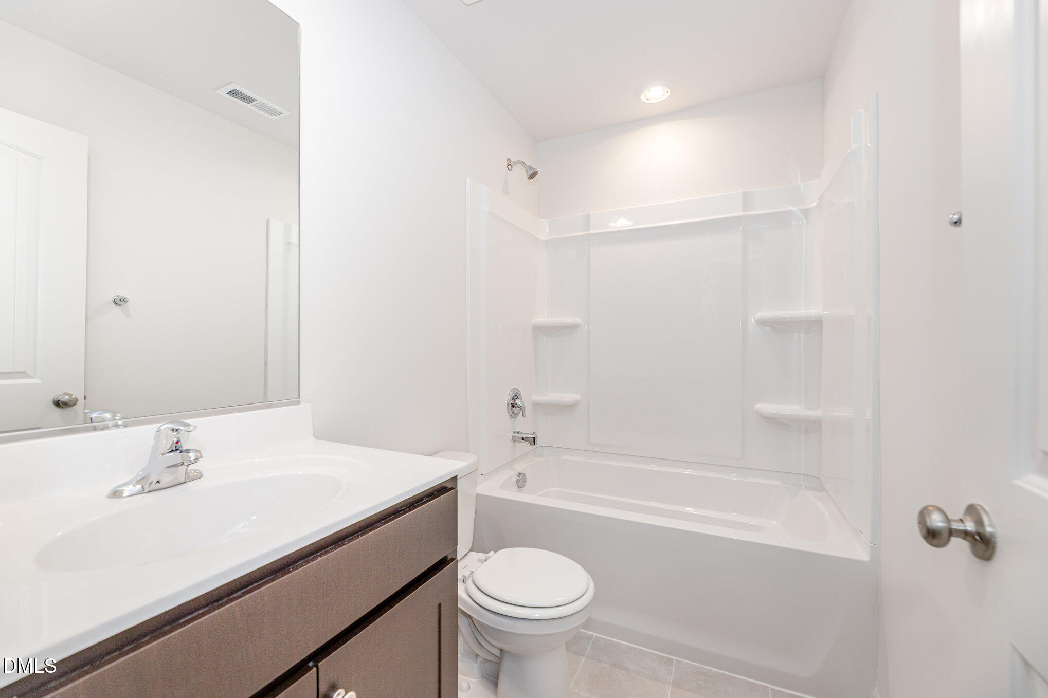2302 Broad Street Durham, NC 27704 - Photo 13 of 16 a bathroom with a sink a toilet and shower