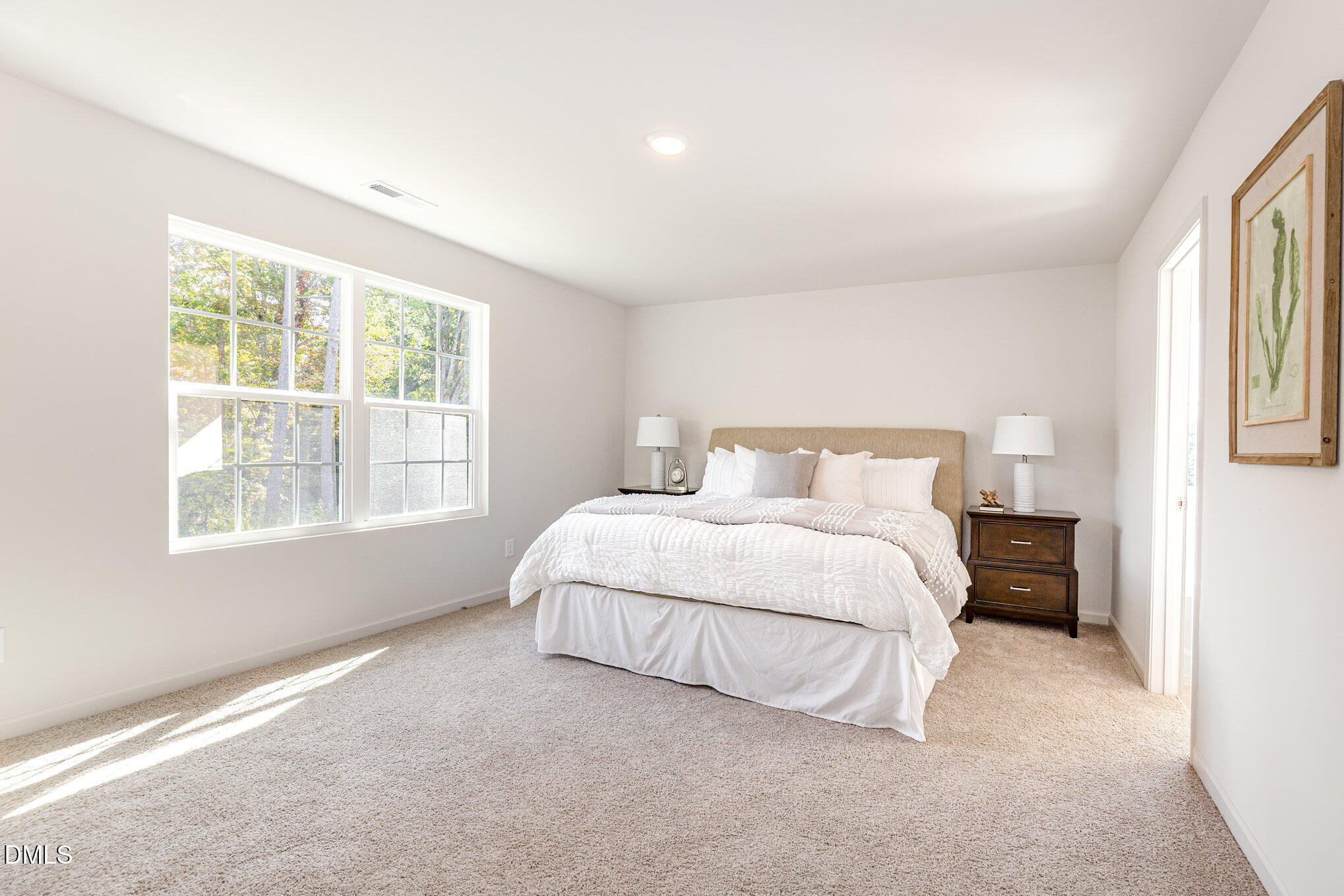 2302 Broad Street Durham, NC 27704 - Photo 10 of 16 a spacious bedroom with a bed and a window