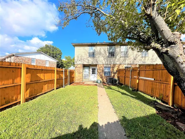 a view of a backyard with swimming pool