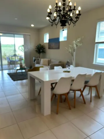 a kitchen with a dining table chairs and stainless steel appliances