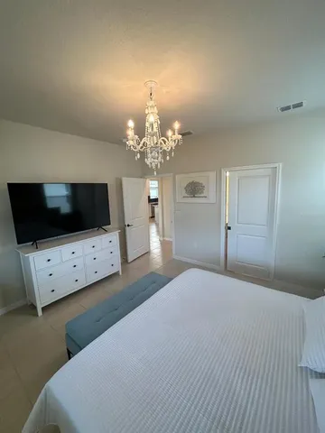 a en suite bathroom with a double vanity sink a mirror and a bathtub